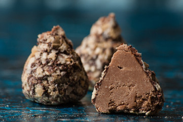 Delicious chocolate candies in waffle crumbs cut in half closeup macro, side view