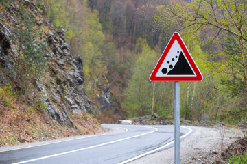 Warning road sign "rockfall collapsed"