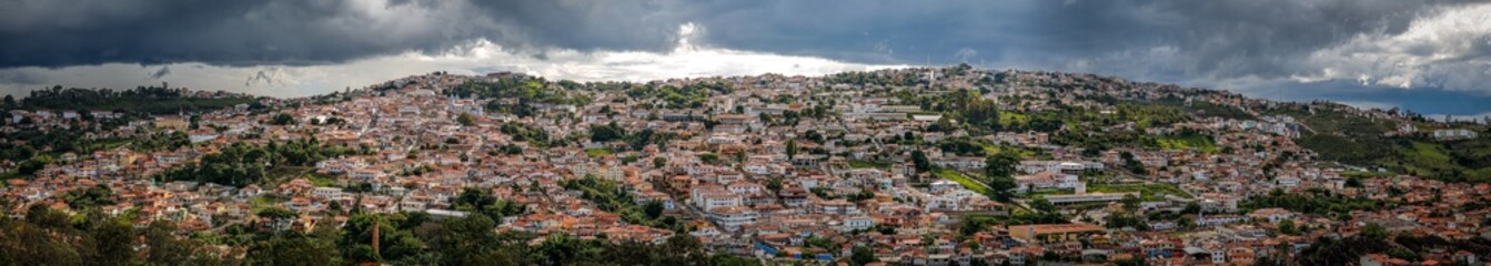 Fototapeta na wymiar Aerial view panorama with sunshine over the historic town center and dramatic dark clouds in the sky, Diamantina, Minas Gerais, Brazil 