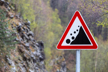 Warning road sign "rockfall collapsed"