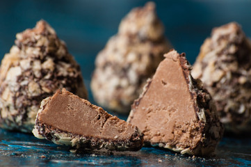 Delicious chocolates in waffle crumbs cut into slices, in half, close-up macro, side view and top view