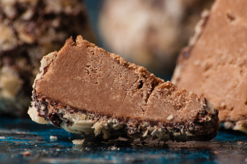Delicious chocolates in waffle crumbs cut into slices, in half, close-up macro, side view and top view