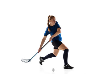 Floorball female player isolated on white studio background. Action and motion, movement, healthy lifestyle and overcoming concept. Young caucasian woman in sportwear training, practicing the game.