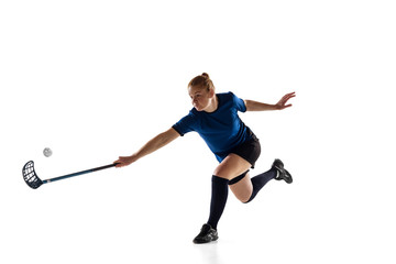 Floorball female player isolated on white studio background. Action and motion, movement, healthy lifestyle and overcoming concept. Young caucasian woman in sportwear training, practicing the game.