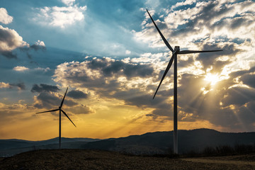 Obraz premium two windmills at sunset