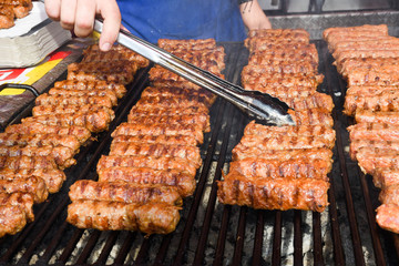 Chef grilling meat during cookout picnic or food event. Meat mix variety, Labour Day, 1 Mai