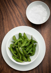 edamame beans snack in bowl on table with sea salt
