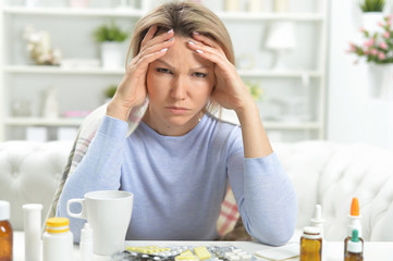 Portrait of beautiful young ill woman at home