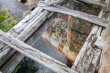 View down through weathered wooden bridge to the creek below, Biribiri State Park, Minas Gerais, Brazil