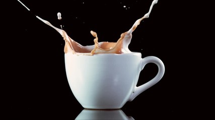 Super slow motion of falling sugar cubes into coffee cup, on black background. Filmed on high speed cinema camera, 1000fps. - Powered by Adobe