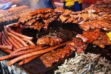 Chef grilling meat during cookout picnic or food event. Meat mix variety, Labour Day, 1 Mai