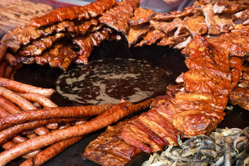 Chef grilling meat during cookout picnic or food event. Meat mix variety, Labour Day, 1 Mai