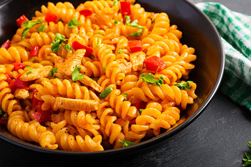 Fusilli pasta with chicken and sweet pepper in tomato sauce. Italian Cuisine.