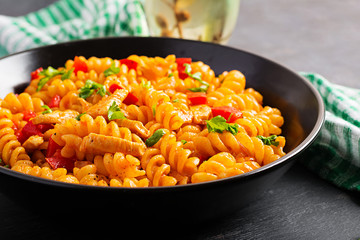 Fusilli pasta with chicken and sweet pepper in tomato sauce. Italian Cuisine.