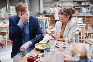 Smiling business man and woman at the table,working  and discussing at cafe.