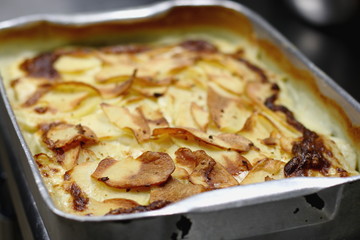 selective focus on roasted creamed potatoes tin, copy space  
