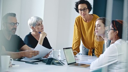 Businessman sharing a report with coworkers during a meeting in the conference room. Corporate professionals meeting in the boardroom.
- Powered by Adobe