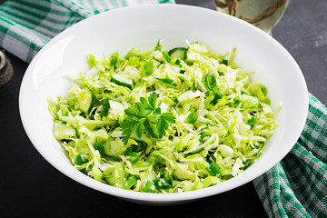 Vegetarian salad. Spring vegan salad with cabbage, cucumber, green onion and parsley.