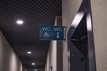 sign about the toilet for men and women in the shopping center