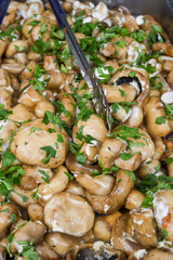 Sauteed mushrooms with garlic and parsley served during catering event.