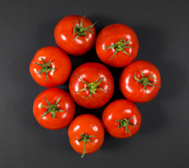 Fresh tomatoes on a black background