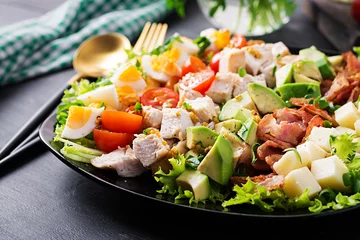 Poster Healthy cobb salad with chicken, avocado, bacon, tomato, cheese and eggs. American food. © timolina
