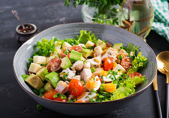 Healthy cobb salad with chicken, avocado, bacon, tomato, cheese and eggs. American food.