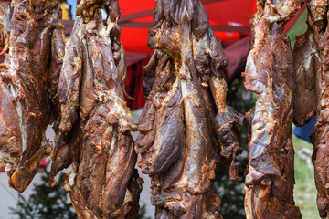 Fresh and raw sheep or lamb meat pieces for sale on the counter top of a butchery shop.