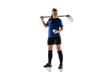 Floorball female player isolated on white studio background. Action and motion, movement, healthy lifestyle and overcoming concept. Young caucasian woman in sportwear training, practicing the game.