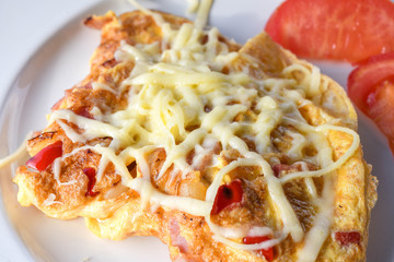 Traditional peasant omelette with ham, cheese, tomatoes, red peppers