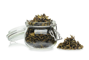 Ivan tea dried in a glass jar isolated on a white background.