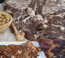 Fresh and raw sheep or lamb meat pieces for sale on the counter top of a butchery shop.