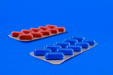 two packs with blue and red tablets.