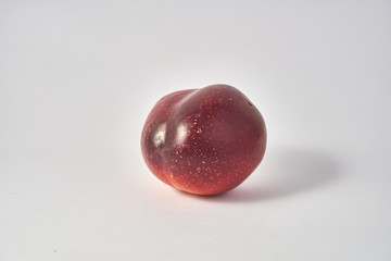 red and orange fruit on white background