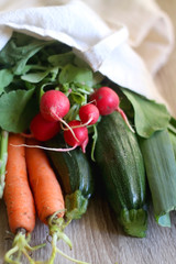 Canvas tote bag with various fresh vegetables. Selective focus.