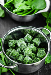 Frozen spinach cubes (close up; selective focus)