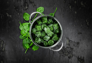 Frozen spinach cubes (close up; selective focus)