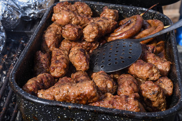 Chef grilling meat during cookout picnic or food event. Meat mix variety, Labour Day, 1 Mai