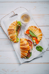 The concept of a hearty and tasty breakfast of fresh classic croissants with a variety of toppings...