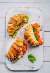 The concept of a hearty and tasty breakfast of fresh classic croissants with a variety of toppings...