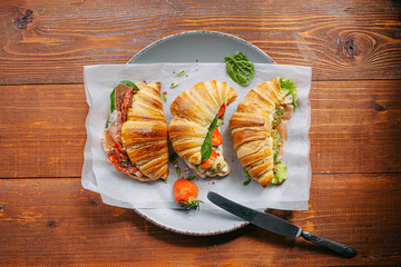 The concept of a hearty and tasty breakfast of fresh classic croissants with a variety of toppings...