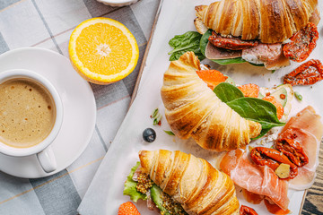 The concept of a hearty and tasty breakfast of fresh classic croissants with a variety of toppings...
