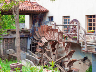 rusty wheel of a disused water mill © gpriccardi