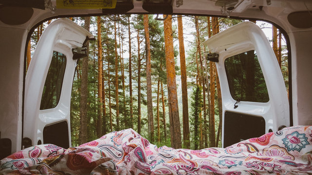 Vistas de bosque desde el port&oacute;n trasero de una furgoneta camper