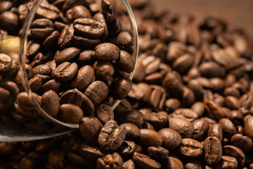 Grains of freshly roasted coffee close-up on a dark background. coffee beans background