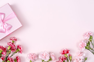 Mother's Day, Valentine's Day background design concept, beautiful pink, red carnation flower bouquet on pink table, top view, flat lay, copy space.