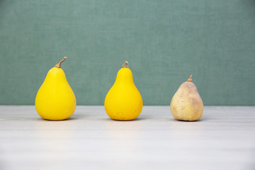 Yellow vegetables and fruits on a green background. Decorative zucchini. New crop. Differ from others. Old age. Allergy. Healthy and sick.