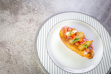 Bruschetta with proscuitto ham, tomatoes and King oyster mushroom. Iitalian style food