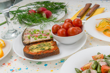Cherry tomatoes and Hot sandwiches of rye bread slices with bacon, cheese, green onions and dill in white bowl. Concept of fast food and nutritious snacks