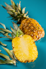 Creative layout made of pineapple on blue background. Tropical flat lay. Food concept. Copy space 